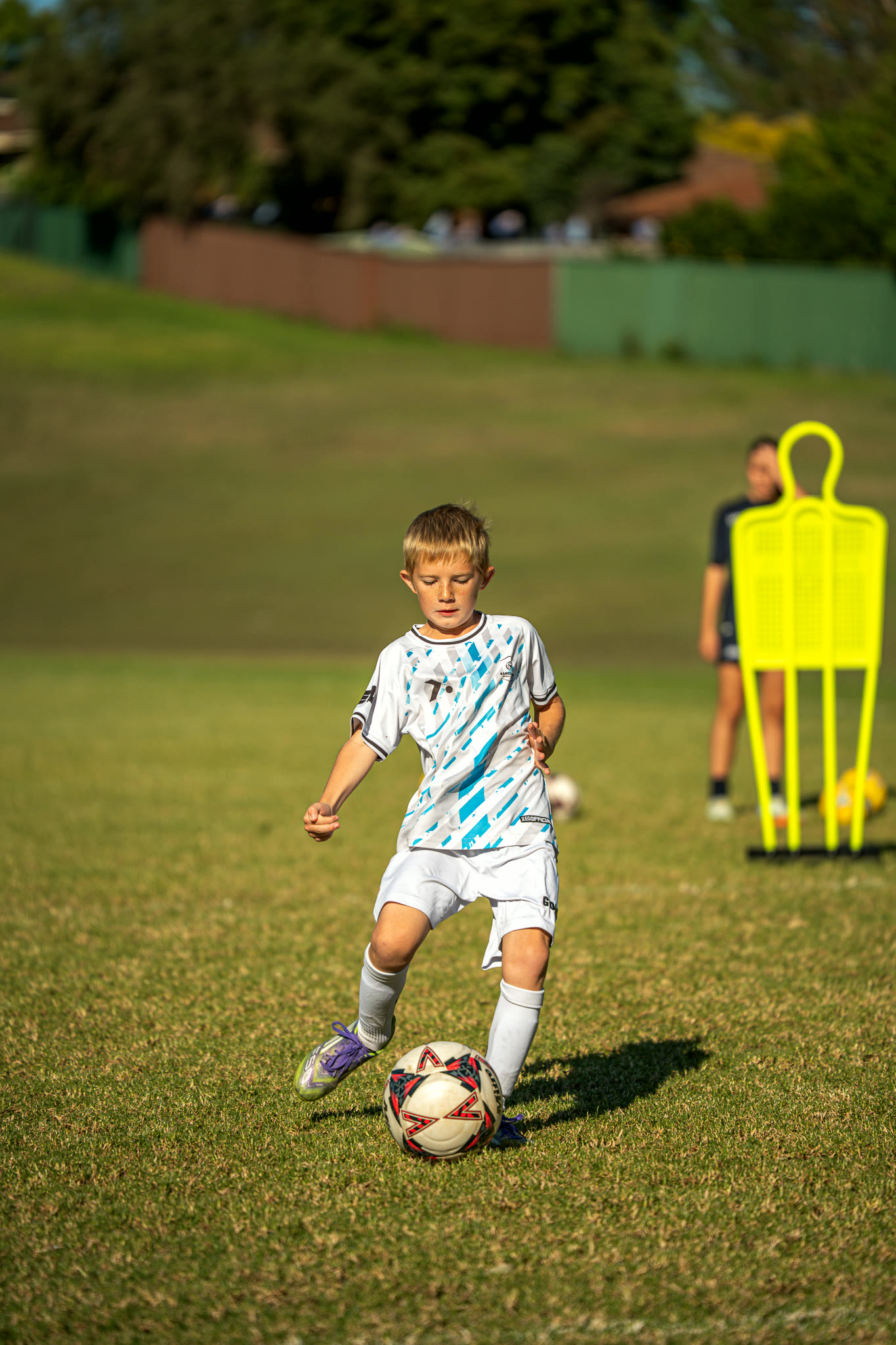 A young Gamechanger player dribbling through a drill during a session.