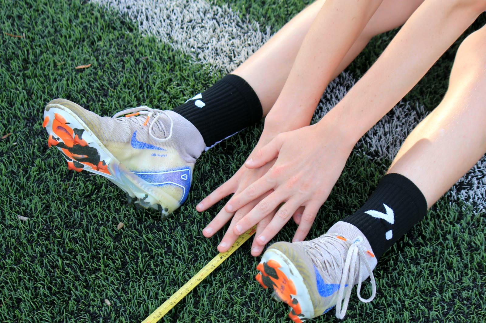 A close-up of an athlete's boots being measured during a testing session.