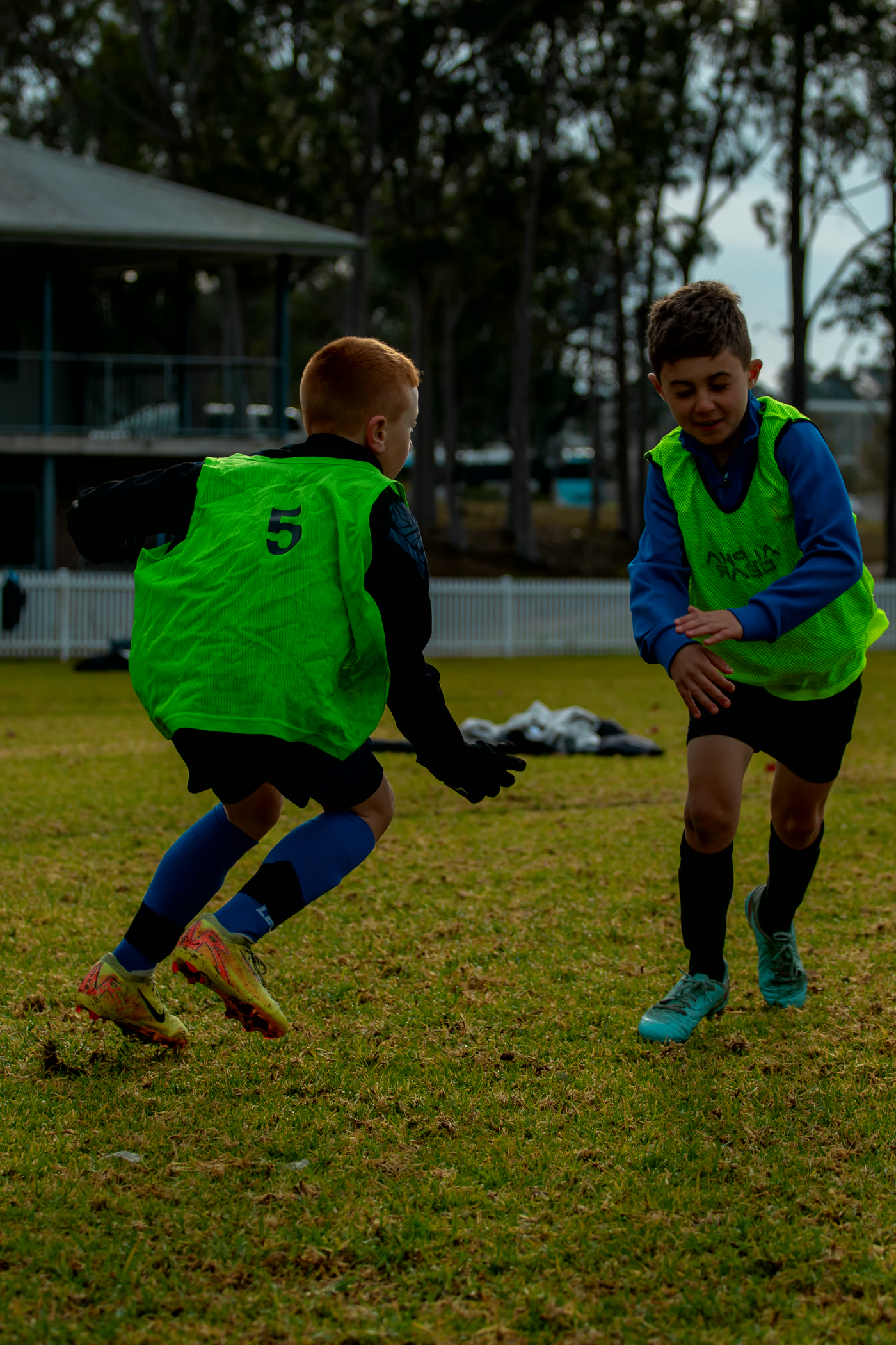 Two players competing for the ball during a camp session.