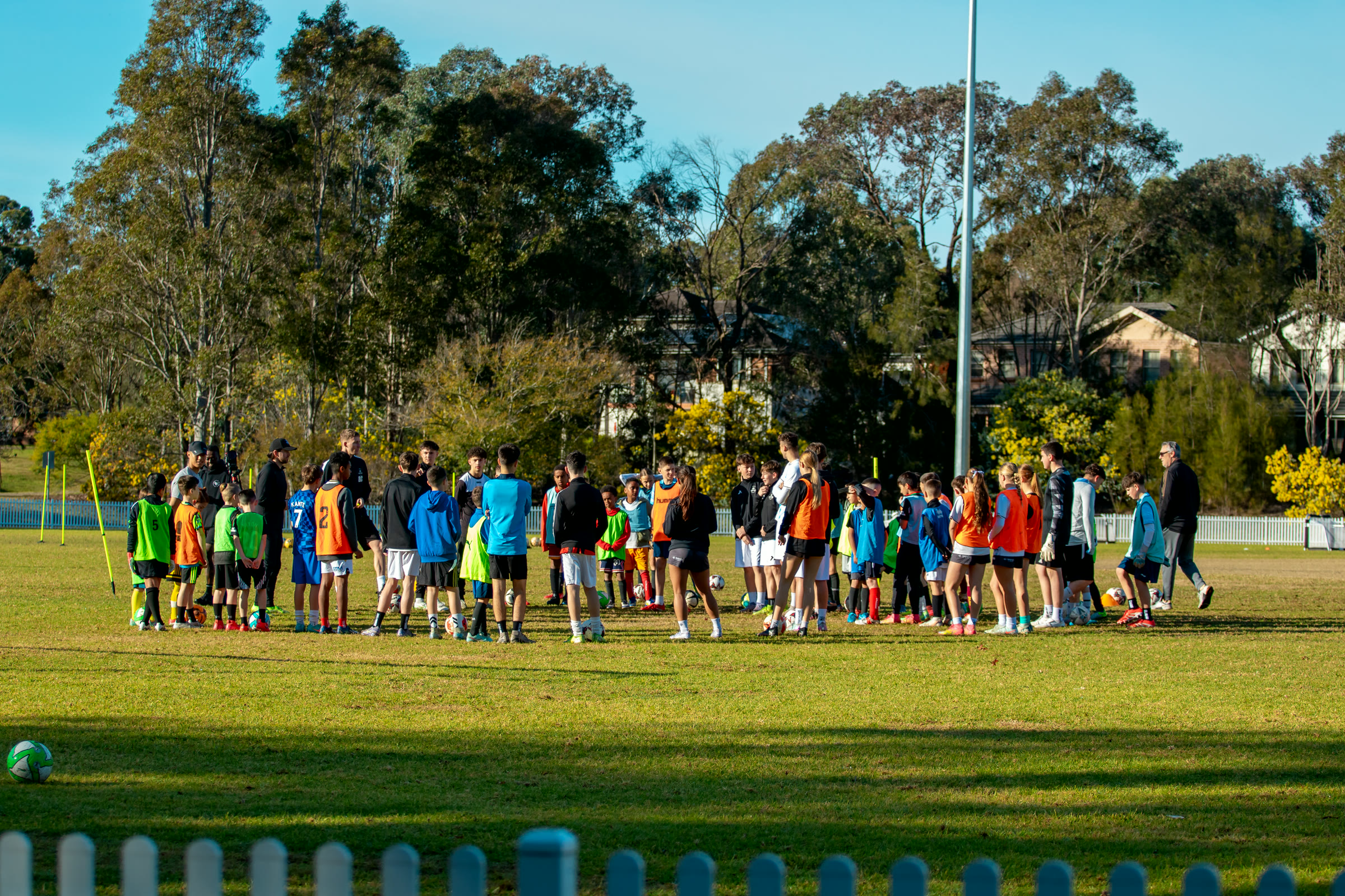A large school holiday camp session across the pitch.