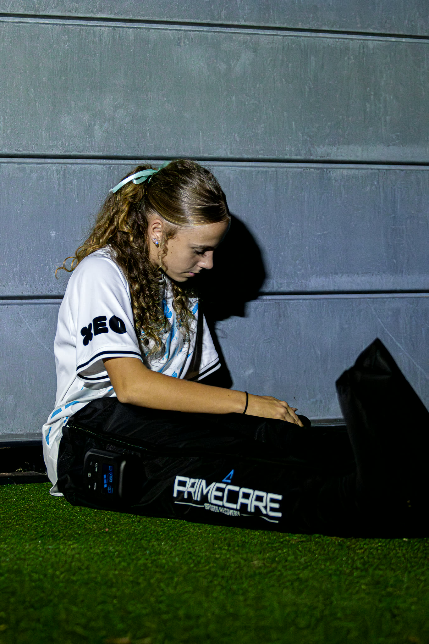 A Gamechanger player recovering in PrimeCare compression boots after a session.