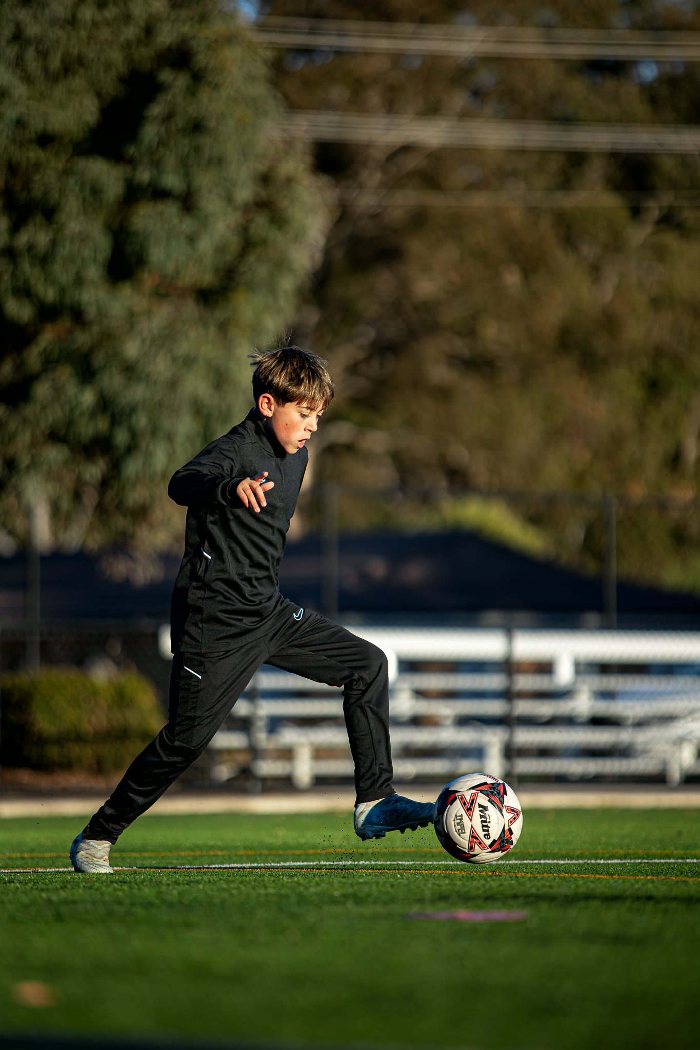 A player driving with the ball during a session.