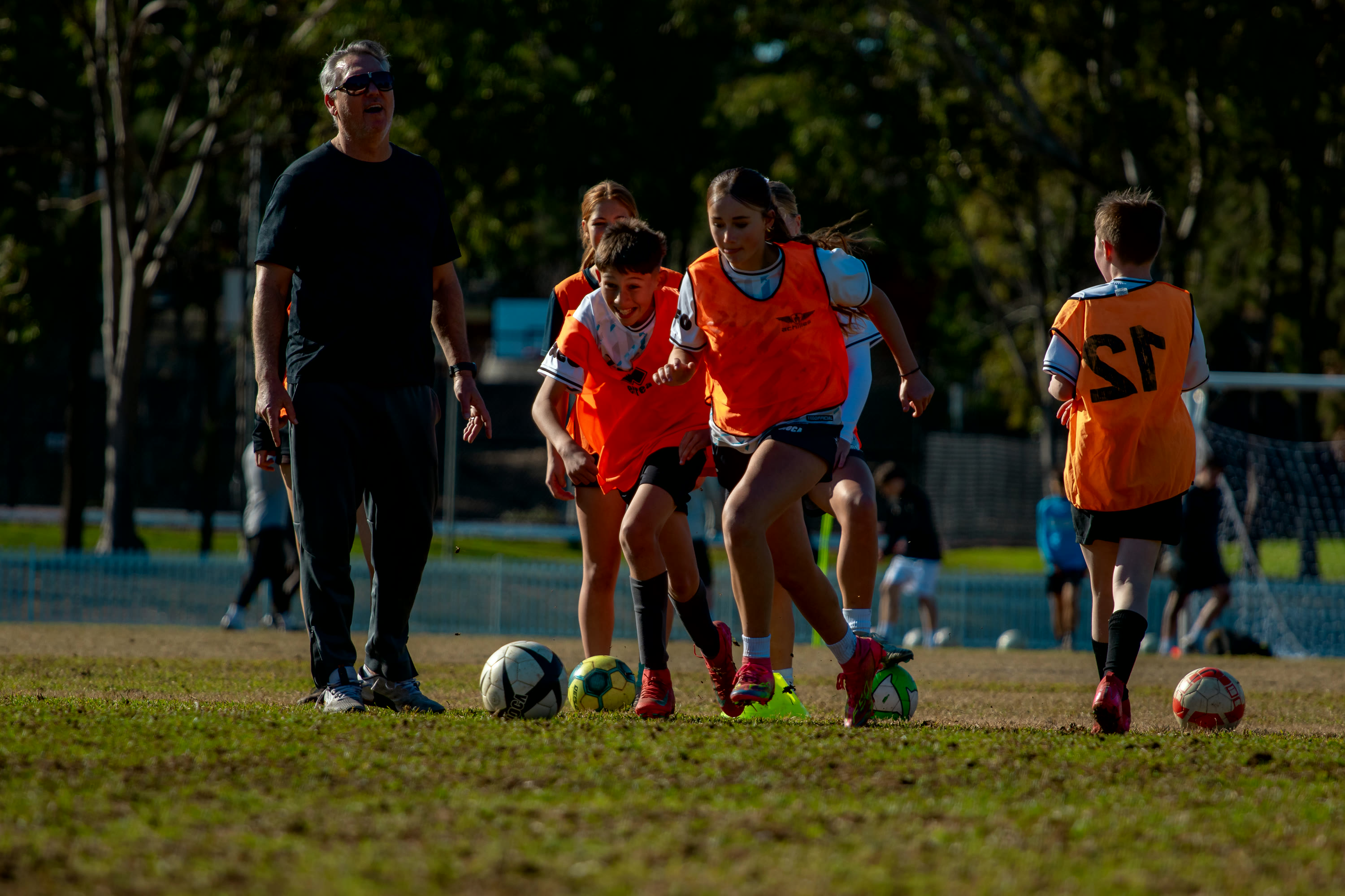 A Gamechanger coach leading a group of players during a school holiday session.
